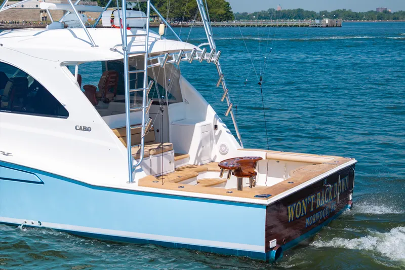  Yacht Photos Pics 2012 Cabo 44 Hardtop Express yacht cruising on a sunny day, featuring a spacious deck.