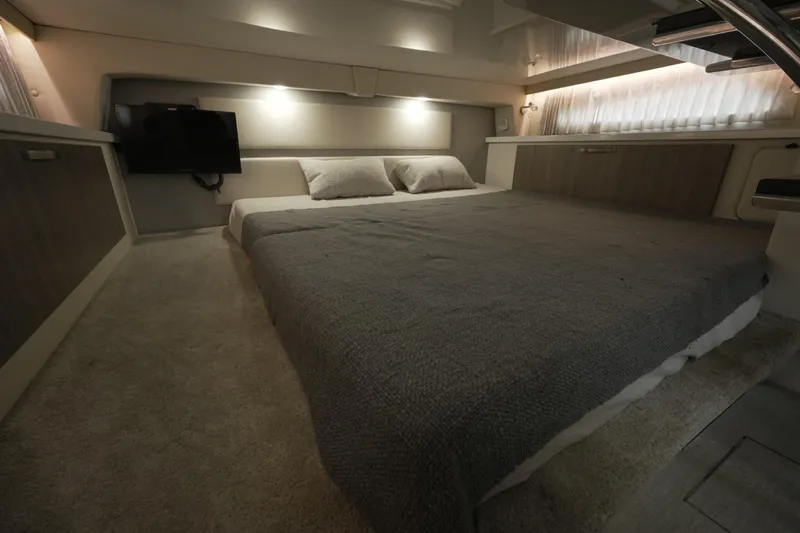  Yacht Photos Pics Luxurious interior cabin of 2021 Regal 33 XO yacht with cozy bedding and ambient lighting.