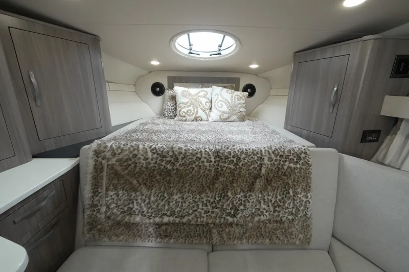  Yacht Photos Pics Luxurious cabin interior of 2021 Regal 33 XO yacht with plush bedding and modern cabinetry.