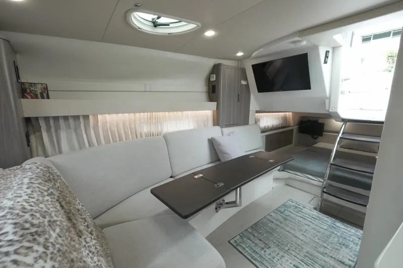  Yacht Photos Pics Luxurious interior of 2021 Regal 33 XO yacht with modern seating and entertainment area.