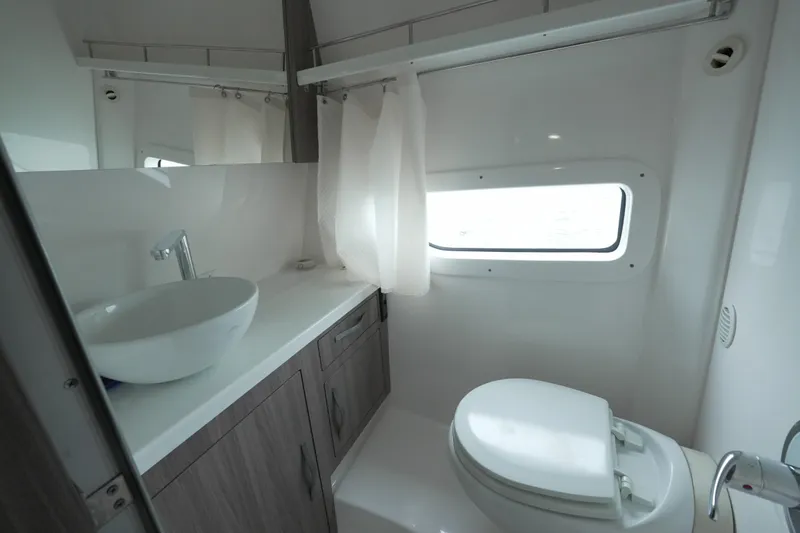  Yacht Photos Pics Modern bathroom in 2021 Regal 33 XO yacht with sink, toilet, and window.