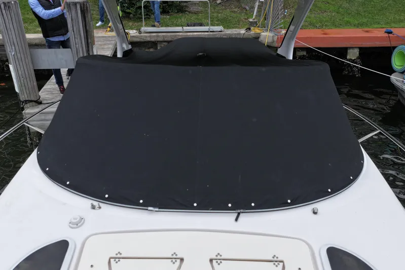  Yacht Photos Pics 2021 Regal 33 XO boat with black cover docked at marina.