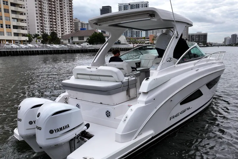  Yacht Photos Pics 2021 Regal 33 XO boat with Yamaha engines on urban waterway.