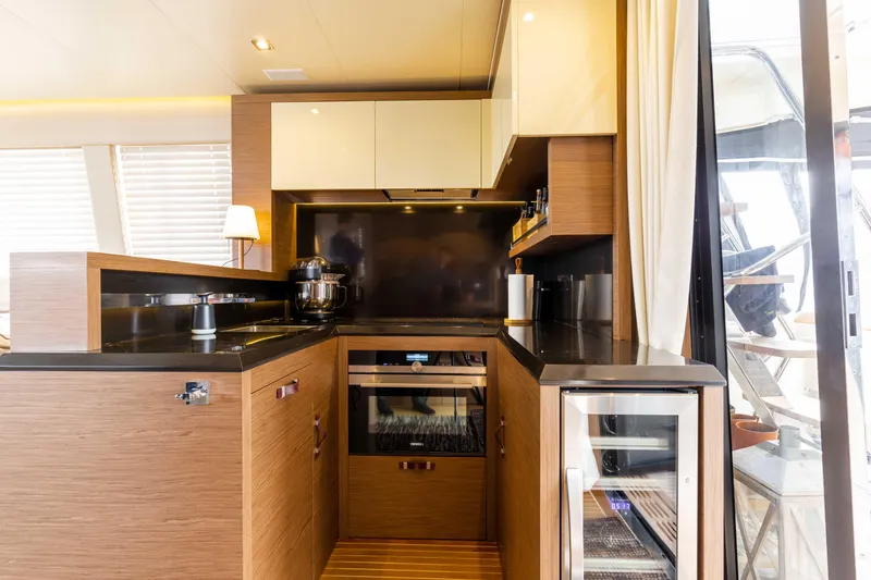  Yacht Photos Pics Luxurious kitchen interior of 2017 Beneteau Monte Carlo 6S yacht with modern appliances.