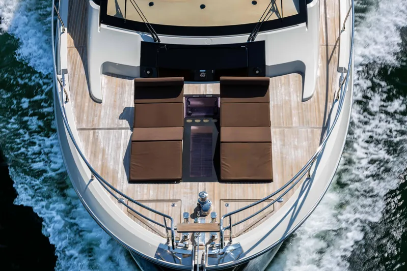  Yacht Photos Pics Luxurious 2017 Beneteau Monte Carlo 6S yacht with sun loungers on deck, cruising through water.