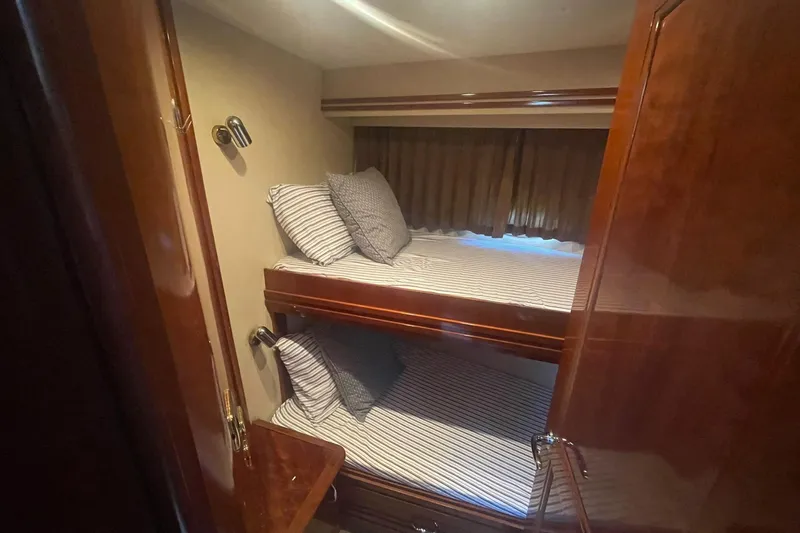 Susea Q Yacht Photos Pics Bunk beds in 2005 Carver 560 Voyager yacht cabin with striped bedding and wooden finish.