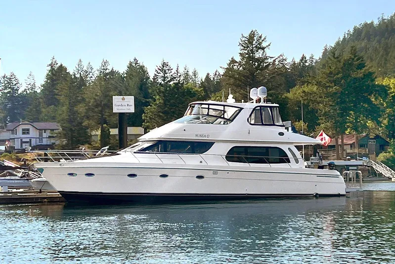 Susea Q Yacht Photos Pics 2005 Carver 560 Voyager yacht docked at a scenic marina with forested background.