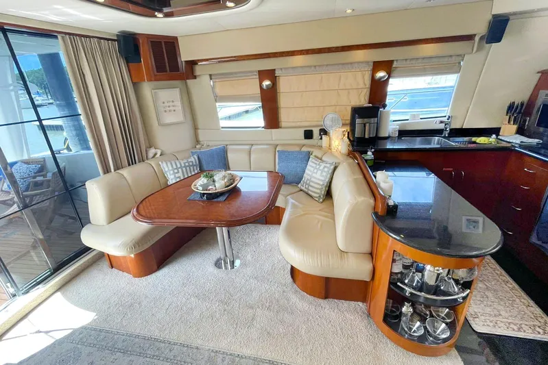 Susea Q Yacht Photos Pics Luxurious interior of 2005 Carver 560 Voyager yacht with elegant seating and modern kitchen amenities.