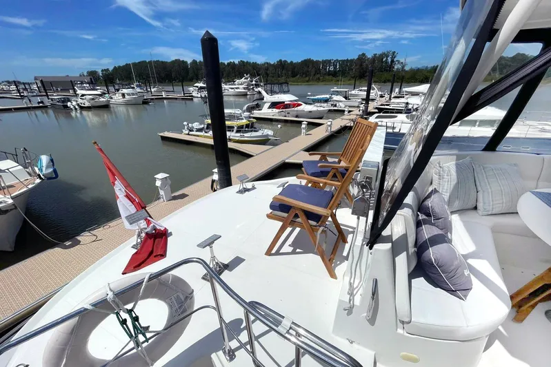 Susea Q Yacht Photos Pics 2005 Carver 560 Voyager yacht docked at marina with seating and Canadian flag.