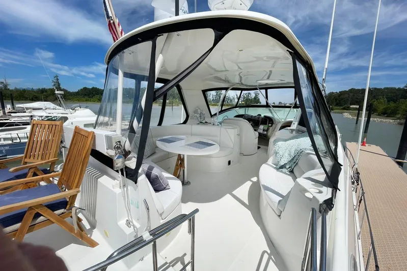 Susea Q Yacht Photos Pics 2005 Carver 560 Voyager yacht with spacious deck, seating, and scenic marina view.