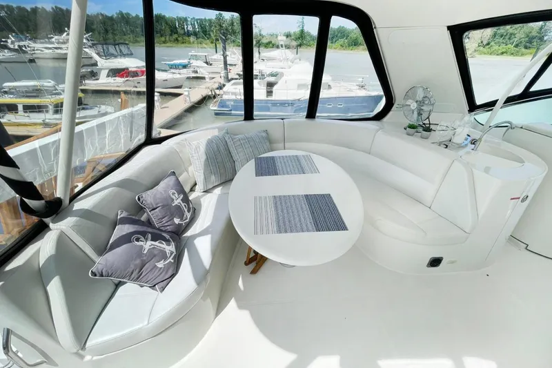 Susea Q Yacht Photos Pics Luxurious 2005 Carver 560 Voyager yacht interior with elegant seating and marina view.