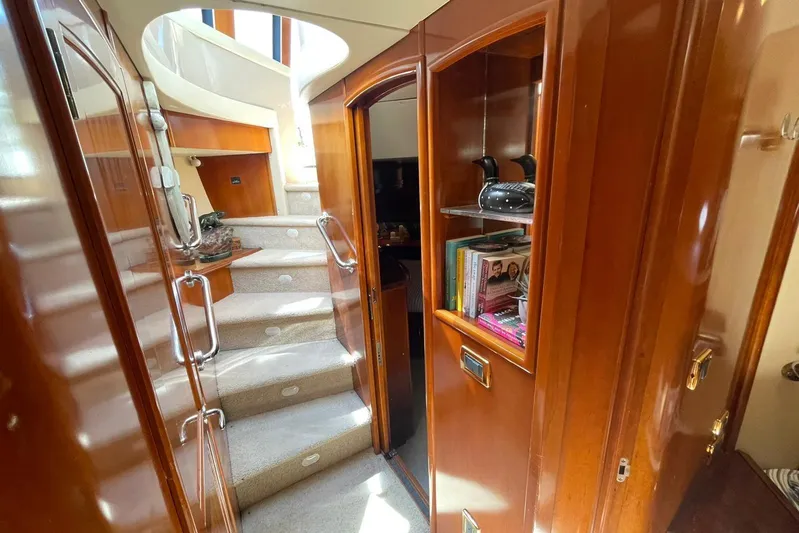Susea Q Yacht Photos Pics Interior of 2005 Carver 560 Voyager yacht with wooden cabinetry and carpeted stairs.