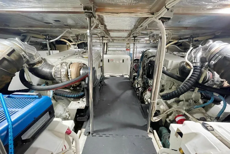 Susea Q Yacht Photos Pics Engine room of a 2005 Carver 560 Voyager yacht, showcasing dual engines and mechanical systems.