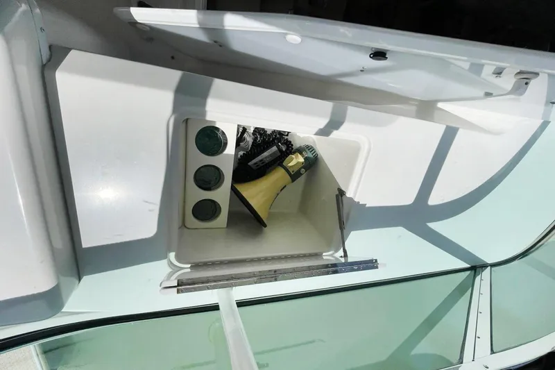 Susea Q Yacht Photos Pics Storage compartment on a 2005 Carver 560 Voyager yacht, featuring a drill and tools.