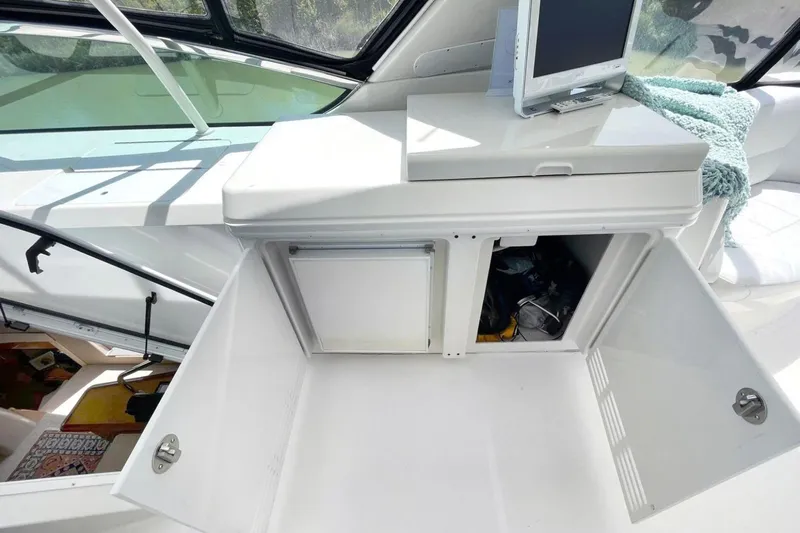 Susea Q Yacht Photos Pics 2005 Carver 560 Voyager interior with open storage compartments and a mounted screen.