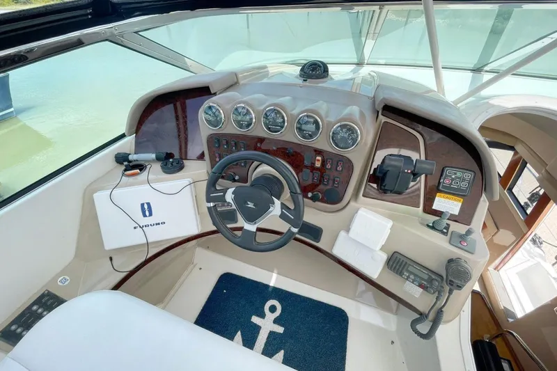 Susea Q Yacht Photos Pics 2005 Carver 560 Voyager helm with steering wheel, gauges, and navigation equipment.