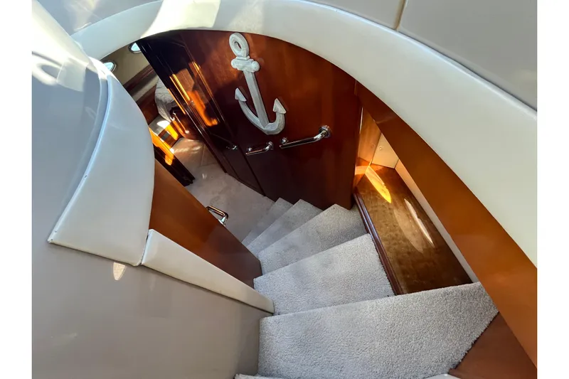 Susea Q Yacht Photos Pics Staircase inside 2005 Carver 560 Voyager yacht with anchor decor on wooden door.