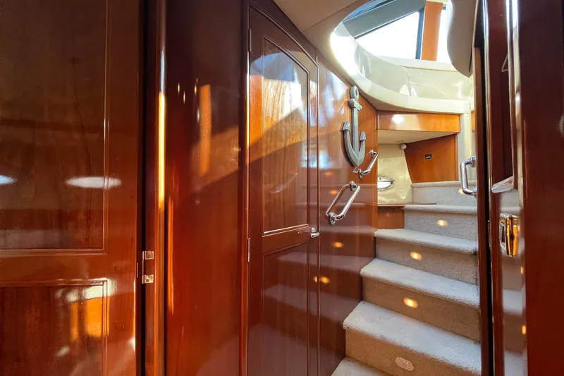 Susea Q Yacht Photos Pics Interior of 2005 Carver 560 Voyager yacht with wooden finishes and carpeted stairs.