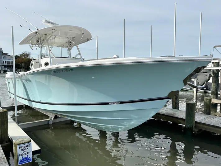  Yacht Photos Pics 2015 Regulator 34 boat docked, light blue hull, private dock sign visible.