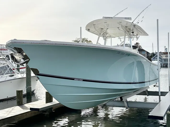  Yacht Photos Pics 2015 Regulator 34 boat docked, showcasing sleek design and light blue hull.