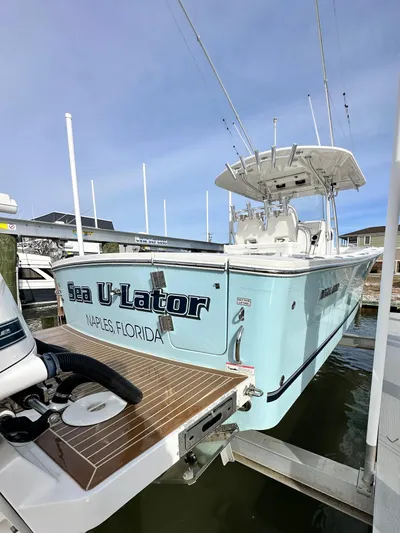  Yacht Photos Pics 2015 Regulator 34 boat docked, light blue hull, "Sea U-Lator" name visible.