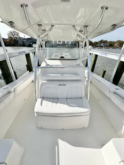  Yacht Photos Pics 2015 Regulator 34 boat with white seating and sleek design, docked by the water.