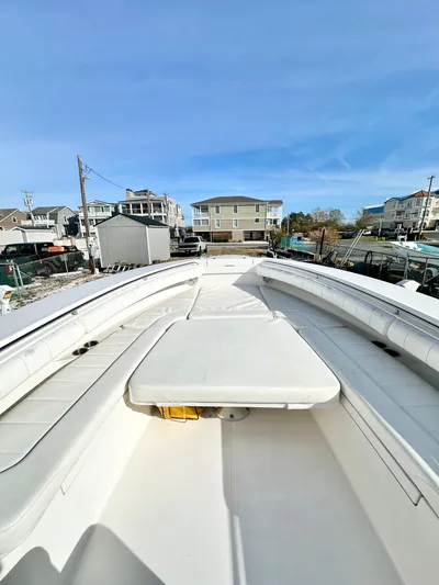 Yacht Photos Pics 2015 Regulator 34 boat with spacious deck and seating, docked in a marina.