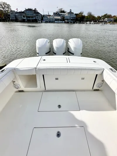  Yacht Photos Pics 2015 Regulator 34 boat with triple engines, docked near waterfront homes.