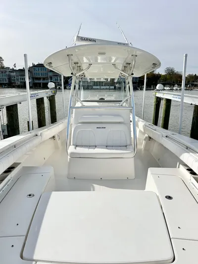  Yacht Photos Pics 2015 Regulator 34 boat docked, featuring spacious deck and seating, with waterfront view.