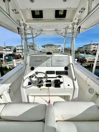  Yacht Photos Pics 2015 Regulator 34 boat cockpit with Garmin navigation, docked in a marina.