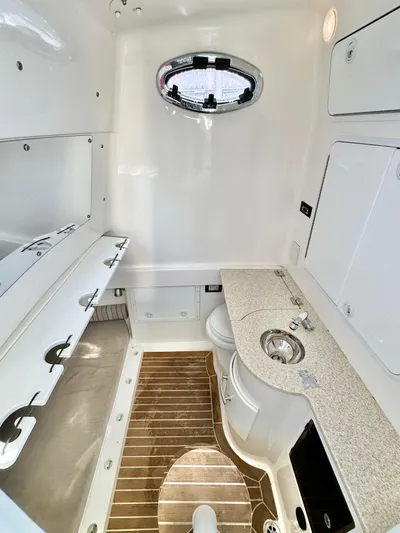  Yacht Photos Pics 2015 Regulator 34 boat interior with sink, wooden flooring, and storage compartments.