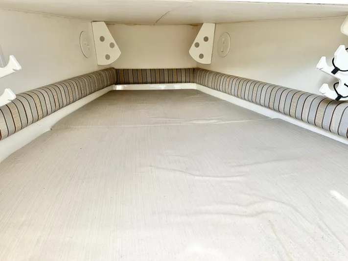  Yacht Photos Pics 2015 Regulator 34 boat interior with cushioned seating and storage space.