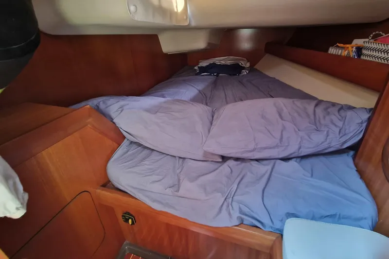  Yacht Photos Pics Cozy cabin interior of 2002 Grand Soleil 43 sailboat with blue bedding.
