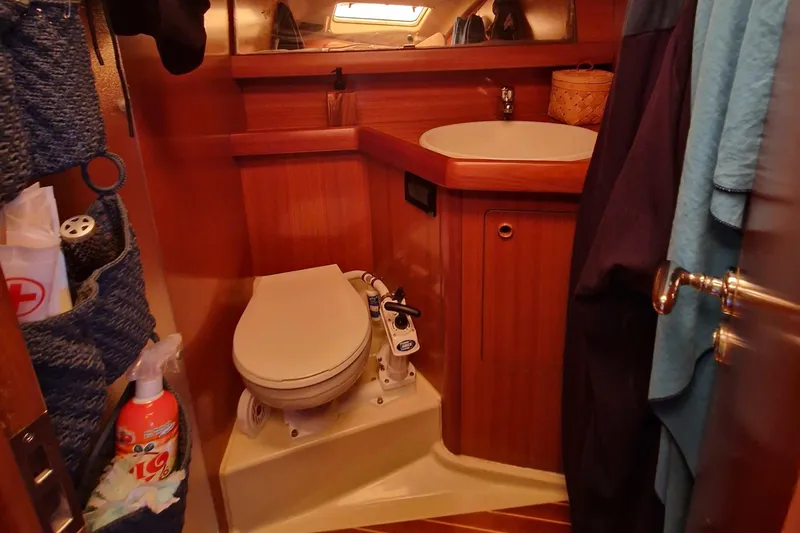  Yacht Photos Pics Grand Soleil 43 yacht bathroom with wooden cabinetry, toilet, and sink, 2002 model.