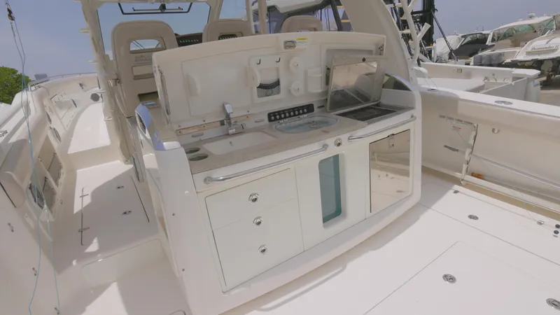  Yacht Photos Pics 2016 Boston Whaler 420 Outrage boat interior with kitchenette and seating area.