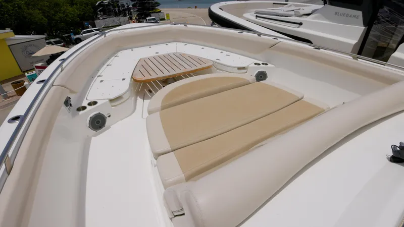  Yacht Photos Pics 2016 Boston Whaler 420 Outrage boat with cushioned seating and wooden table.