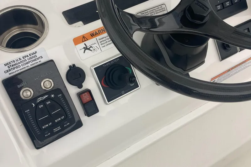  Yacht Photos Pics 2022 Regulator 34 boat dashboard with steering wheel and control panel.