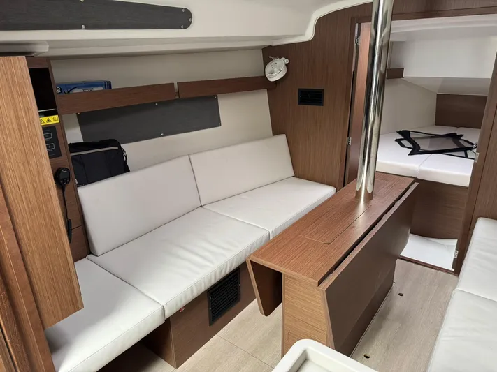 Xanadu Yacht Photos Pics 2024 Beneteau Oceanis 34.1 interior with modern wood finish and white seating.