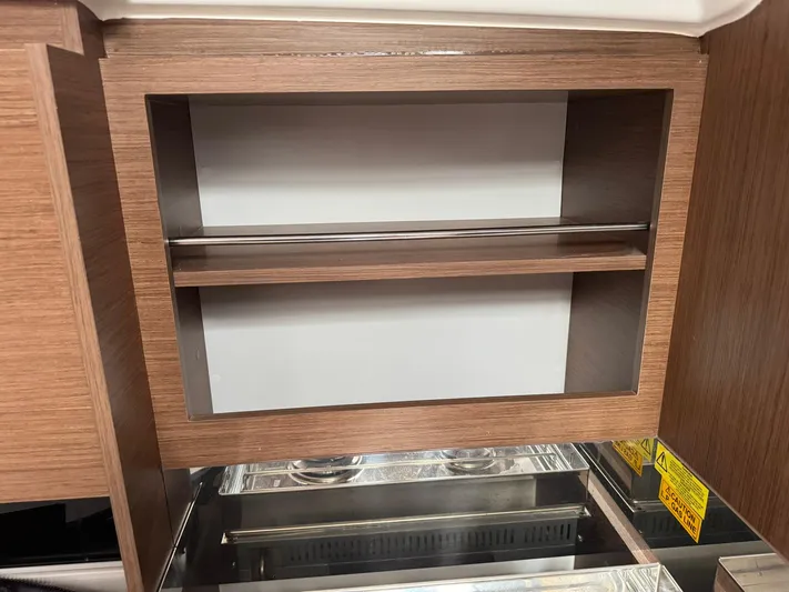 Xanadu Yacht Photos Pics 2024 Beneteau Oceanis 34.1 interior wooden cabinet with shelf and modern design.