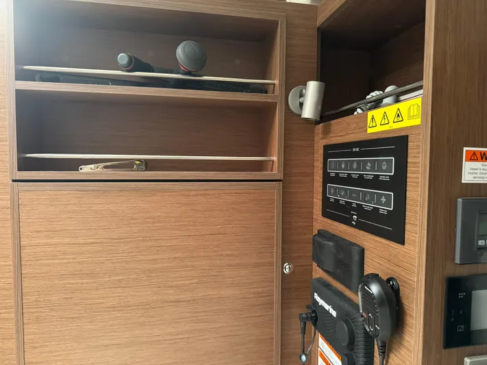 Xanadu Yacht Photos Pics Interior of 2024 Beneteau Oceanis 34.1 yacht with wooden cabinetry and control panel.