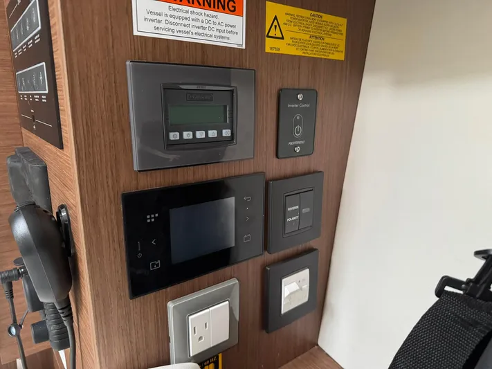 Xanadu Yacht Photos Pics Control panel of a 2024 Beneteau Oceanis 34.1 yacht, featuring various switches and displays.