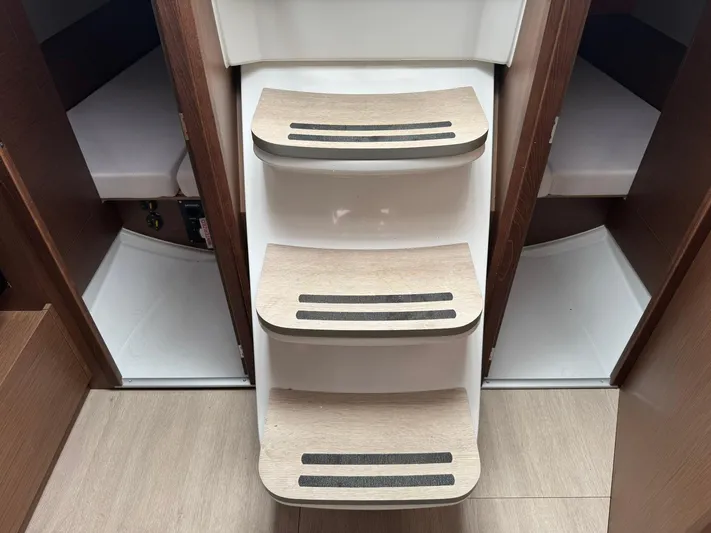 Xanadu Yacht Photos Pics 2024 Beneteau Oceanis 34.1 interior stairs with wood finish and non-slip strips.