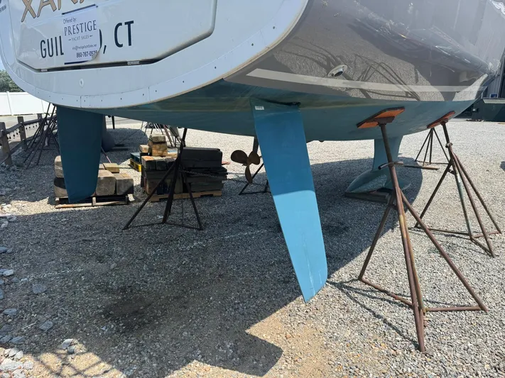 Xanadu Yacht Photos Pics 2024 Beneteau Oceanis 34.1 sailboat on stands, displayed outdoors.