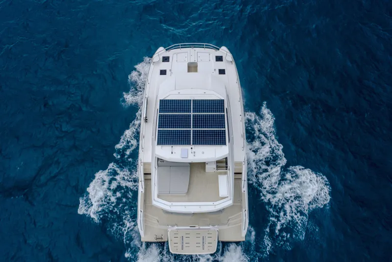 Althea Yacht Photos Pics 2025 Leopard 53 Powercat with solar panels cruising on blue ocean waters.