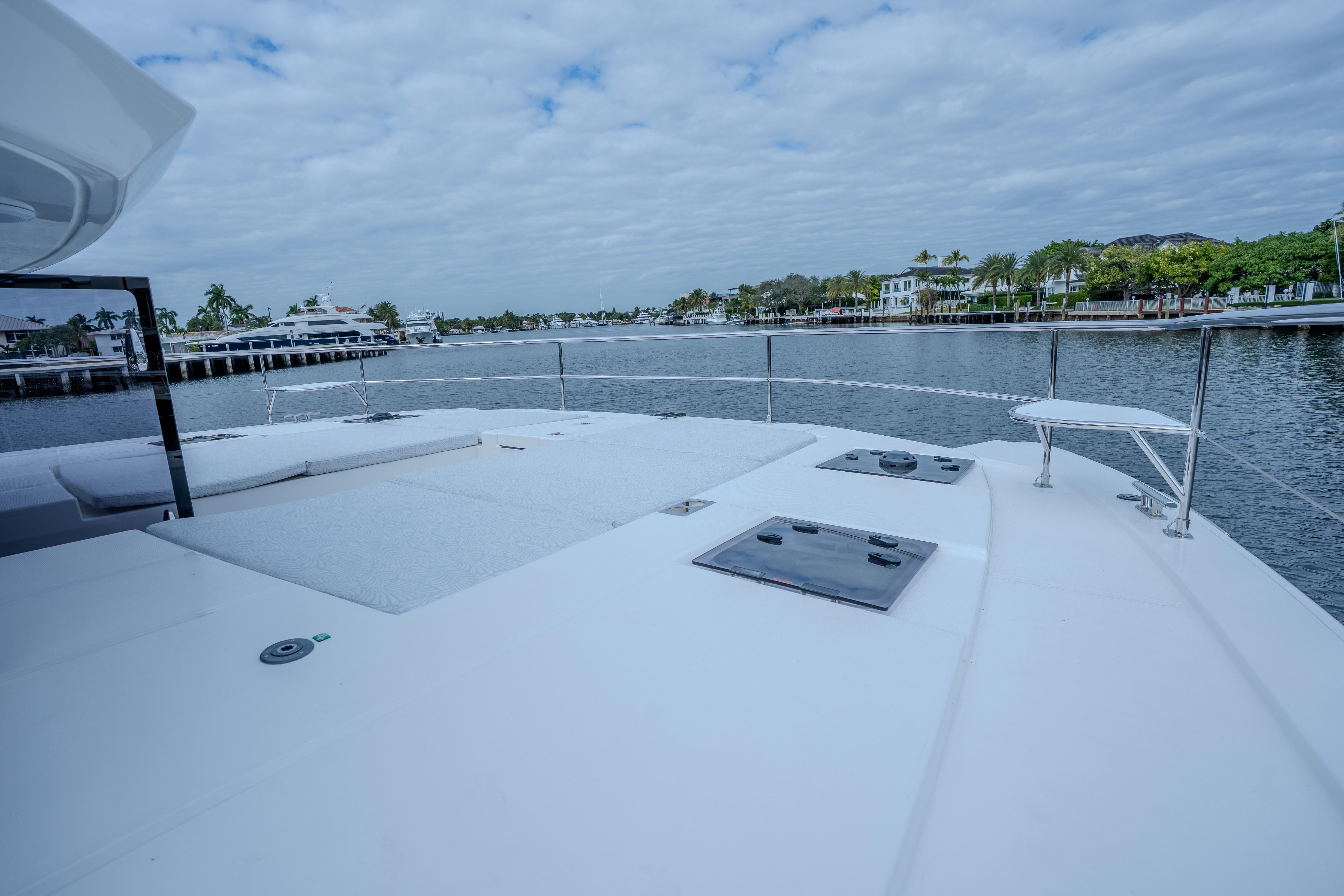 2025 Leopard 53 Powercat yacht deck with waterfront view and luxurious seating.