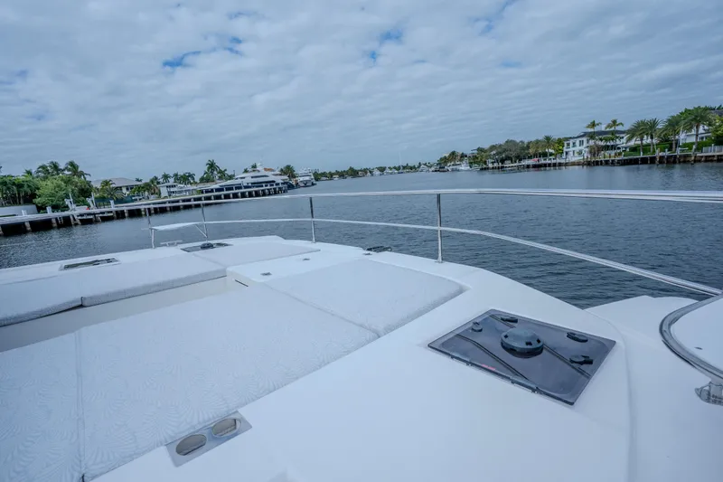 Althea Yacht Photos Pics 2025 Leopard 53 Powercat yacht deck with scenic waterfront view.