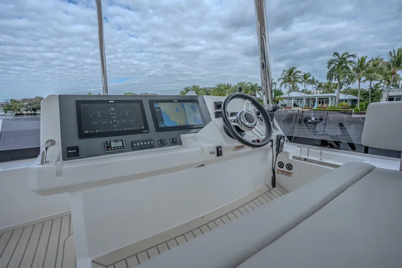 Althea Yacht Photos Pics Helm of 2025 Leopard 53 Powercat with modern navigation displays and steering wheel.