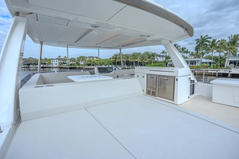 Althea Yacht Photos Pics Spacious deck of 2025 Leopard 53 Powercat with modern amenities and scenic waterfront view.