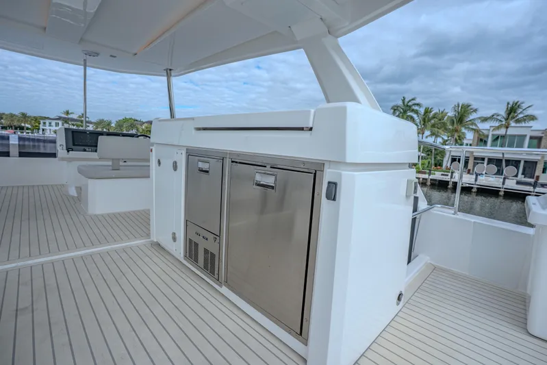 Althea Yacht Photos Pics 2025 Leopard 53 Powercat yacht deck with modern outdoor kitchen and seating area.