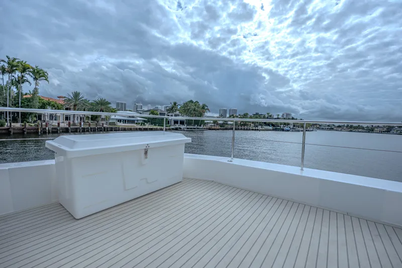 Althea Yacht Photos Pics Deck view of 2025 Leopard 53 Powercat yacht with scenic waterfront backdrop.